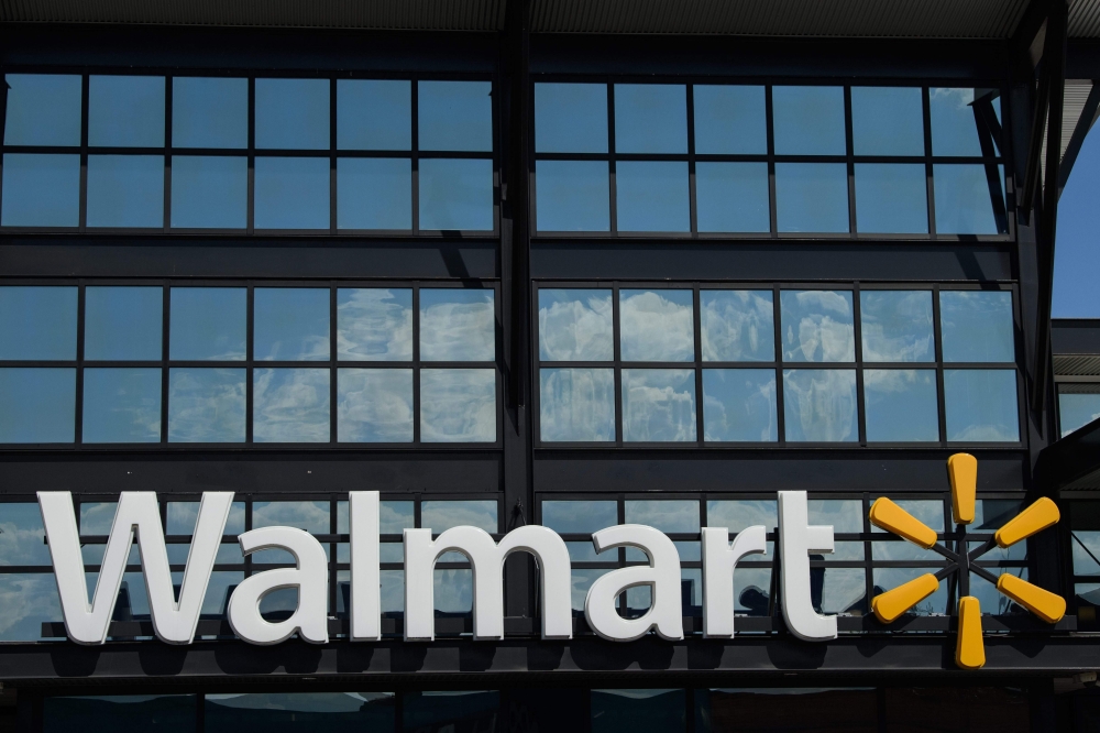 In this file photo a Walmart logo is seen outside a store in Washington, DC, on August 18, 2020. US retail giant Walmart said on August 27, 2020 it had teamed with Microsoft in a bid to buy short-form video app TikTok. / AFP / NICHOLAS KAMM