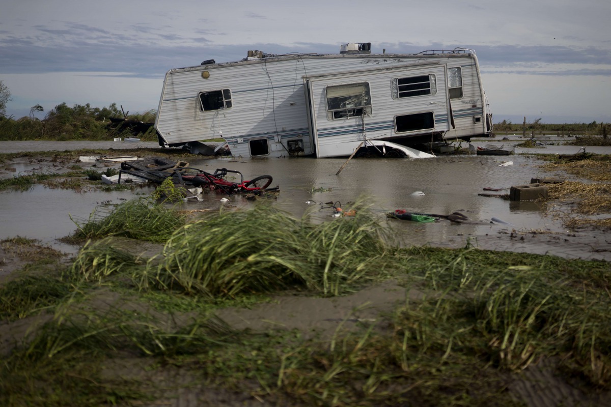 HOLLY BEACH, LA - AUGUST 27: A damaged travel trailer sits among flood water after Hurricane Laura passed through the area August 27, 2020 in Holly Beach, Louisiana. Hurricane Laura came ashore bringing rain and high winds to the South East region of the 