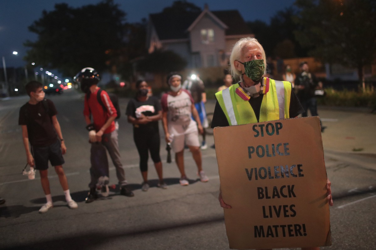 KENOSHA, WISCONSIN - AUGUST 26: Demonstrators protest the shooting of Jacob Blake on August 26, 2020 in Kenosha, Wisconsin. A police officer shot Blake seven times in the back in front of his three children. The shooting sparked three consecutive days of 
