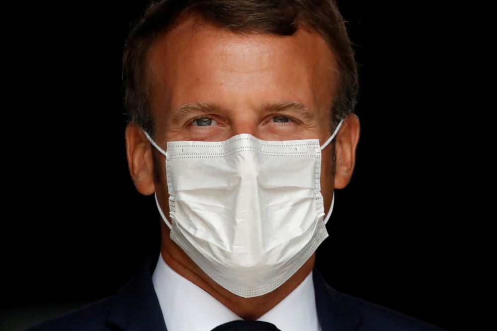 French President Emmanuel Macron, wearing a protective face mask, visits a site of pharmaceutical group Seqens, a global leader on the production of active pharmaceutical ingredients, to mobilize innovation and support the research on the coronavirus dise