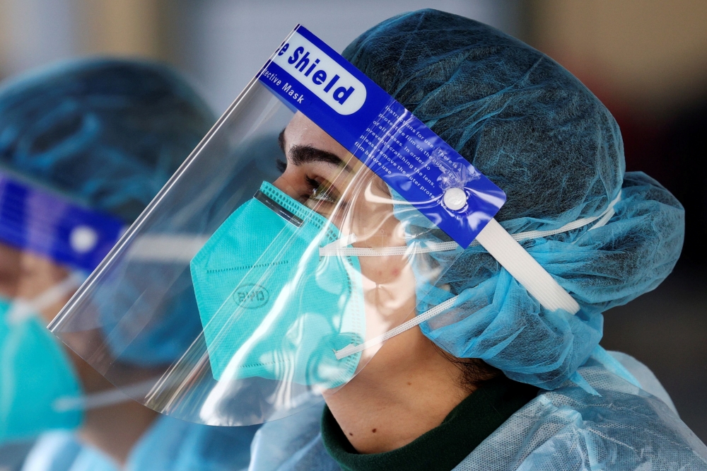 Medical personnel is pictured wearing a BYD Care N95 particulate respirator mask and a face shield while working at a pop-up testing centre for the coronavirus disease (COVID-19), as the state of New South Wales grapples with an outbreak of new cases, in 