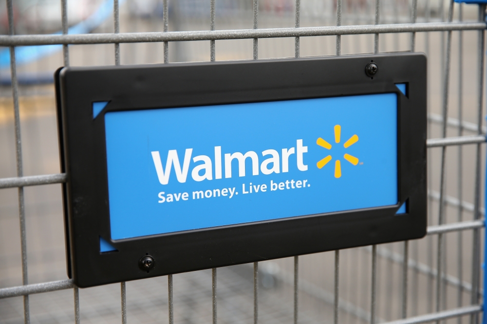 In this file photo the Walmart logo is displayed on a shopping cart at a Walmart store on August 15, 2013 in Chicago, Illinois. US retail giant Walmart said on August 27, 2020 it had teamed with Microsoft in a bid to buy short-form video app TikTok. / AFP