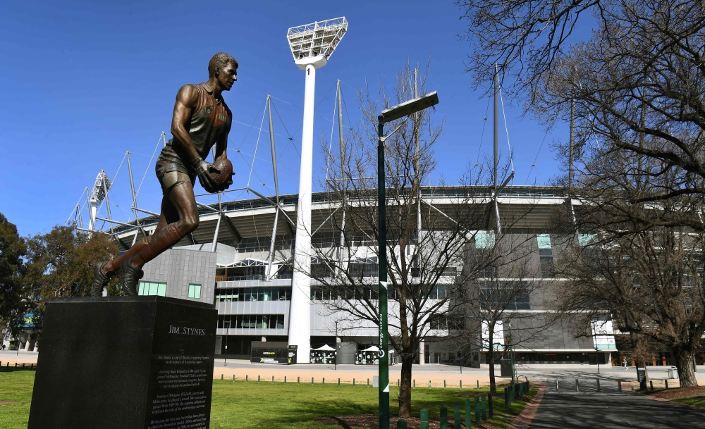 A sculpture of former Aussie Rules footballer player Jim Stynes is displayed outside the Melbourne Cricket Ground (MCG), the spiritual home of Australian Rules Football (AFL), in Melbourne on September 2, 2020. / AFP / William WEST