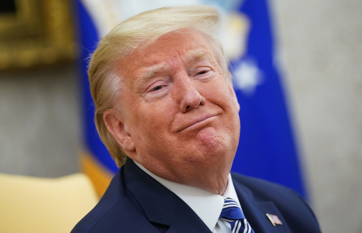 (FILES) In this file photo US President Donald Trump smiles as he meets with Florida Governor Ron DeSantis in the Oval Office of the White House in Washington, DC on April 28, 2020. / AFP / MANDEL NGAN