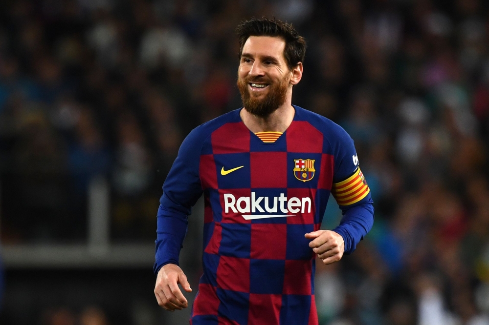 In this file photo taken on March 01, 2020, Barcelona's Argentine forward Lionel Messi smiles during the Spanish League football match between Real Madrid and Barcelona at the Santiago Bernabeu stadium in Madrid. / AFP / GABRIEL BOUYS