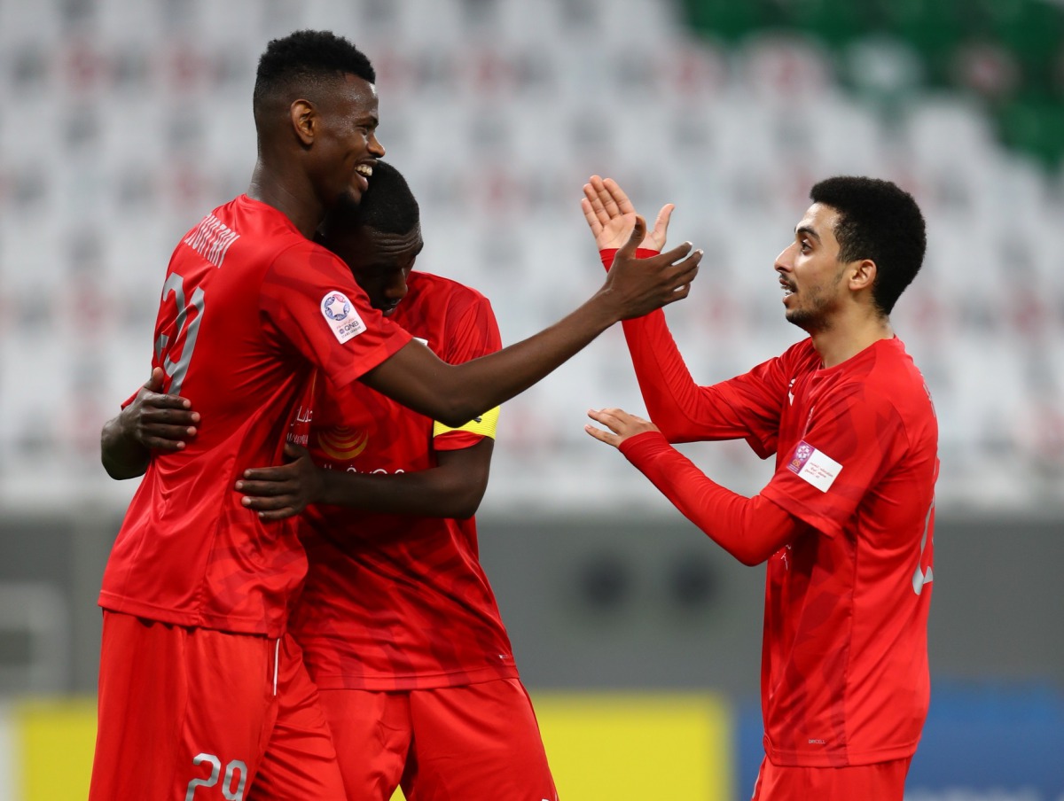 Al Duhail's Mohammed Muntari is being congratulated by team-mates after he scored the team's second goal against Umm Salal, yesterday. 