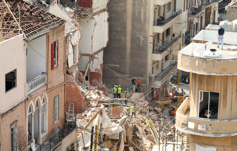 Volunteers and a Chilean rescue team member dig through the rubble of buildings which collapsed due to the explosion at the port area, after signs of life were detected, in Gemmayze, Beirut, Lebanon September 5, 2020. REUTERS/Mohamed Azakir