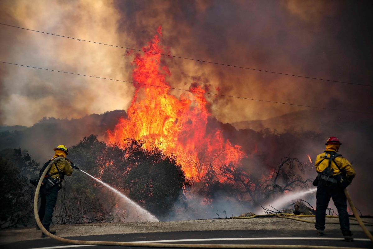 San Miguel County Firefighters battle a brush fire along Japatul Road during the Valley Fire in Jamul, California on September 6, 2020 The Valley Fire in the Japatul Valley burned 4,000 acres overnight with no containment and 10 structures destroyed, Cal 