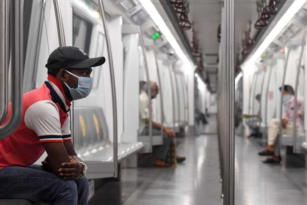 Commuters sit in a carriage of a Yellow Line train after Delhi Metro Rail Corporation (DMRC) resumed services following its closure due to the Covid-19 Coronavirus pandemic in New Delhi on September 7, 2020. / AFP / Prakash SINGH