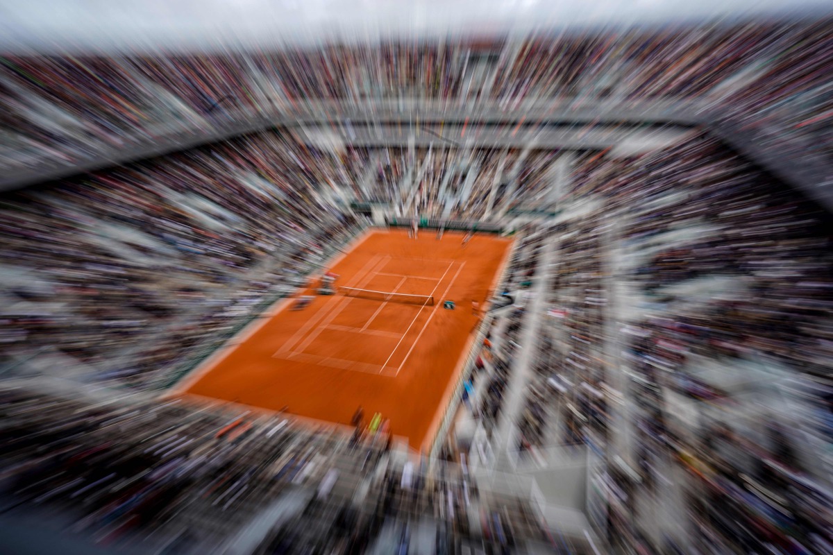 (FILES) In this file photo taken on June 7, 2019, Spain's Rafael Nadal returns the ball to Switzerland's Roger Federer during their men's singles semi-final match on day 13 of The Roland Garros 2019 French Open tennis tournament in Paris./ AFP / Kenzo TRI