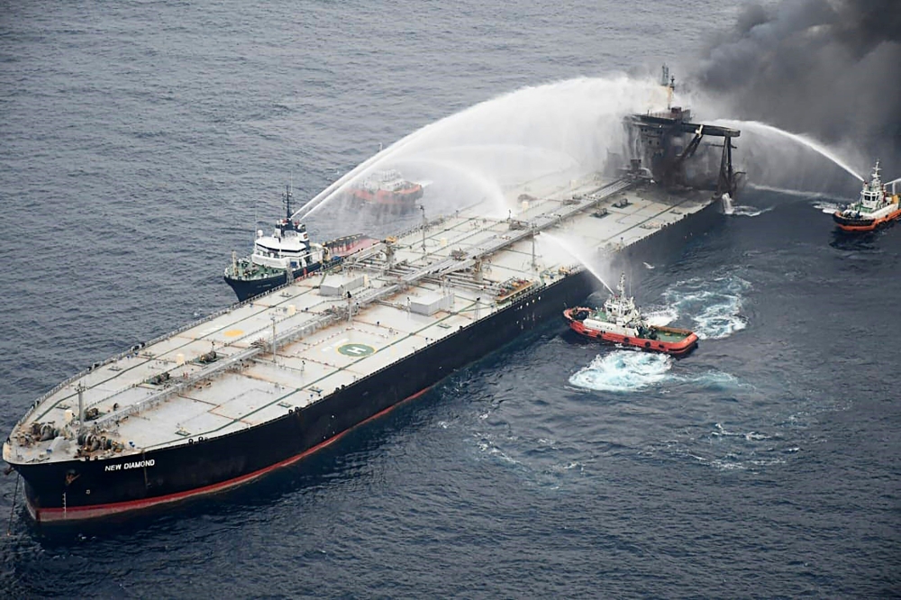 This handout photograph taken on September 8, 2020, and released by Sri Lanka's Air Force shows fireboats battling to extinguish a fire on the Panamanian-registered crude oil tanker New Diamond, some 60 km off Sri Lanka's eastern coast where a fire was re