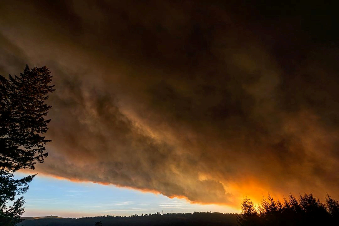 Thick smoke is seen above Salem City, Oregon, U.S., September 8, 2020, in this picture obtained from social media. Picture taken September 8, 2020. ZAK STONE/via REUTERS