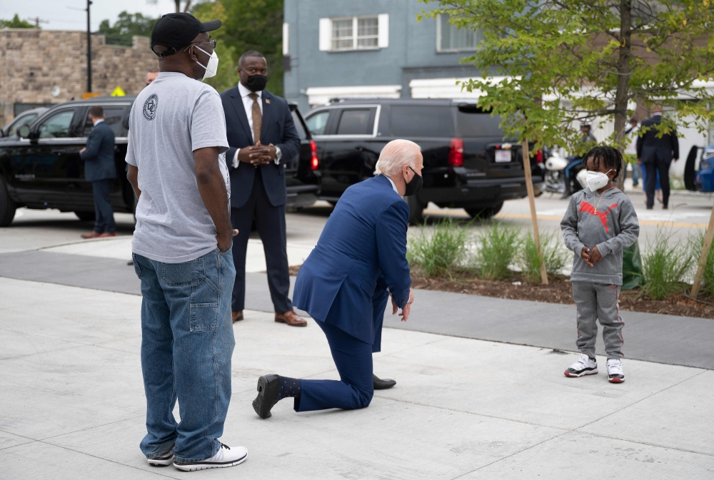 Democratic Presidential Candidate Joe Biden speaks CJ Brown (R), the owner's son, as he shops for his grandkids at the Three Thirteen store in Detroit, Michigan, on September 9, 2020. AFP / Jim Watson 