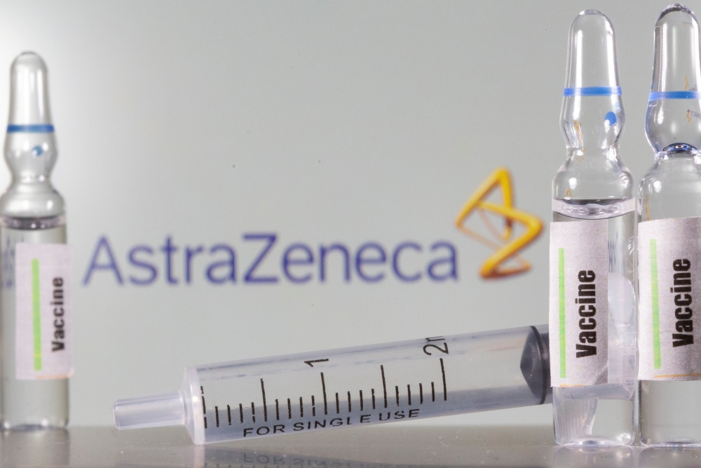 A test tube labelled with the Vaccine is seen in front of AstraZeneca logo in this illustration taken, September 9, 2020. REUTERS/Dado Ruvic