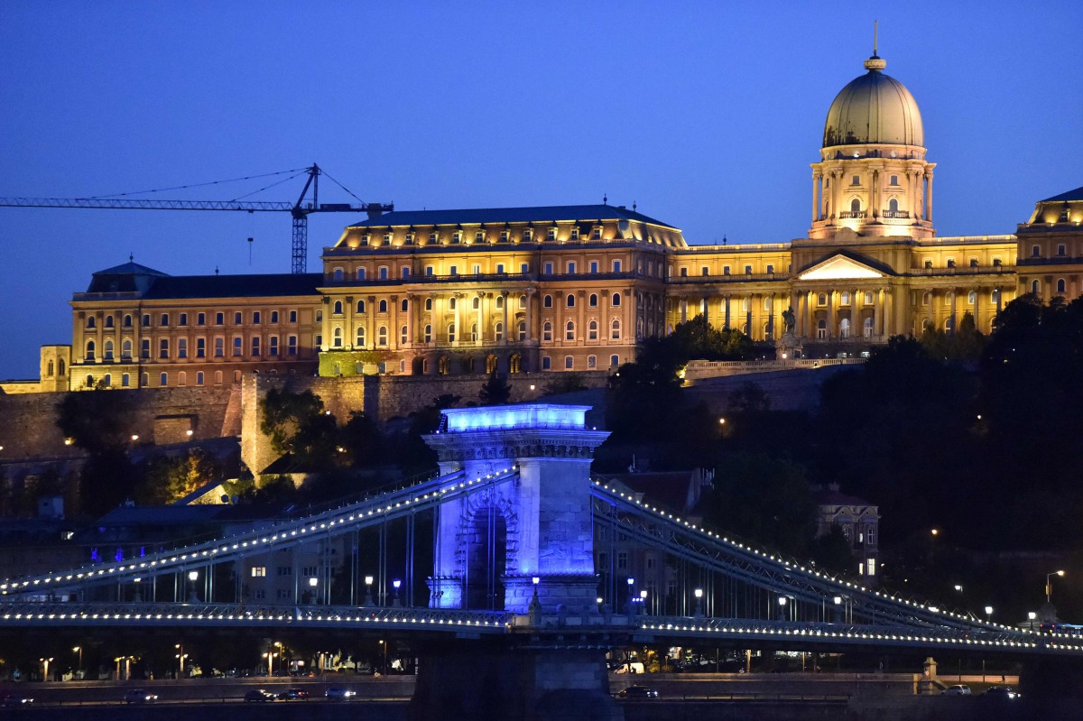 As part of a conference about the live events in the coronavirus situation, the oldest Hungarian bridge, the 'Lanchid' (Chain Bridge) is illuminated by blue light in Budapest on September 9, 2020. The conference, the 'Power of live events' will be held in