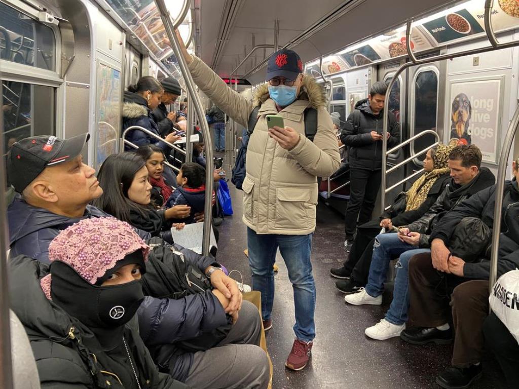 FILE PHOTO: A man with a face mask rides the subway in the Queens borough of New York City, U.S. February 2, 2020. REUTERS/Nick ZieminskiREUTERS