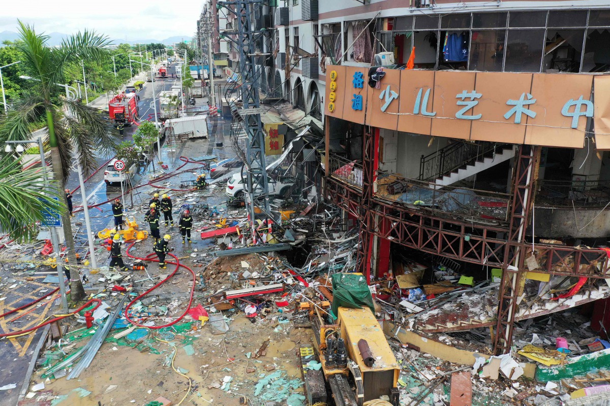 TOPSHOT - Firefighters work at the scene of an explosion in Zhuhai, in China's southern Guangdong province on September 11, 2020. At least three people were injured on September 11 when a gas pipe exploded in a store in the southern city of Zhuhai, local 