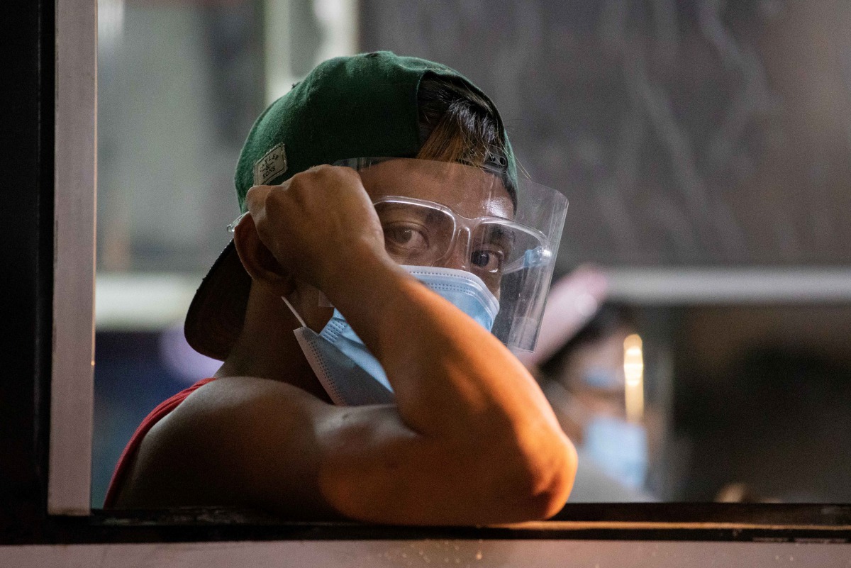 A passenger wears a face mask and face shield on board a bus, amid the coronavirus disease (COVID-19) outbreak, in Quezon City, Metro Manila, Philippines, September 7, 2020. REUTERS/Eloisa Lopez
