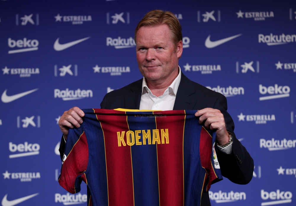 Barcelona unveil new coach Ronald Koeman - Auditorium 1899, Barcelona, Spain - August 19, 2020 Barcelona coach Ronald Koeman poses with a Barcelona shirt during the unveiling REUTERS/Albert Gea/File Photo