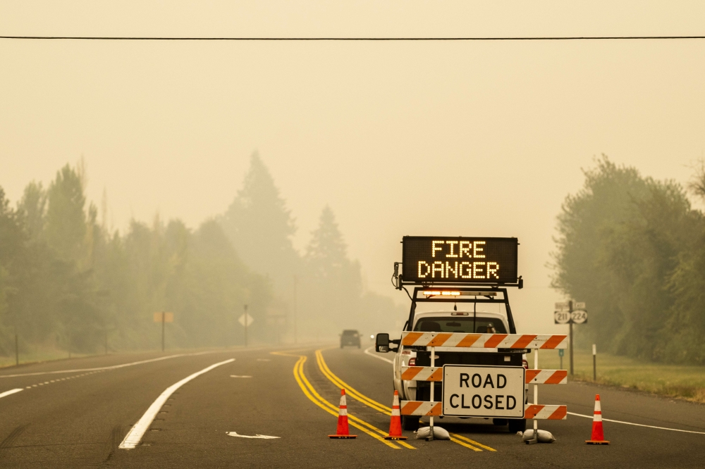 A sign warning of impending fire danger is posted on September 10, 2020 in Estacada, Oregon. Multiple wildfires grew by hundreds of thousands of acres Thursday, prompting large-scale evacuations throughout the state. Nathan Howard/Getty Images/AFP