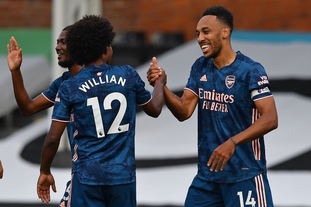 Arsenal's Gabonese striker Pierre-Emerick Aubameyang (R) celebrates scoring their third goal with Arsenal's Brazilian midfielder Willian (L) during the English Premier League football match between Fulham and Arsenal at Craven Cottage in London on Septemb