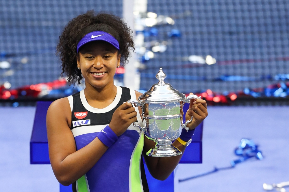 Naomi Osaka of Japan celebrates with the trophy after winning her Women's Singles final match against Victoria Azarenka of Belarus on Day Thirteen of the 2020 US Open at the USTA Billie Jean King National Tennis Center on September 12, 2020 in the Queens 
