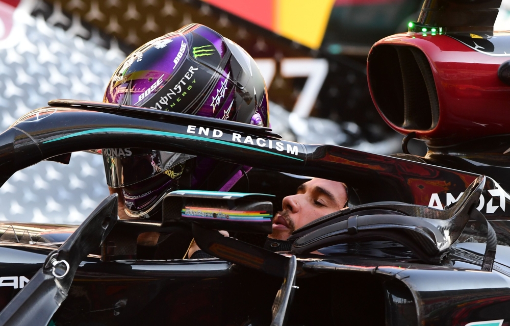 Mercedes' Lewis Hamilton celebrates after winning the race Pool via REUTERS/Jennifer Lorenzini