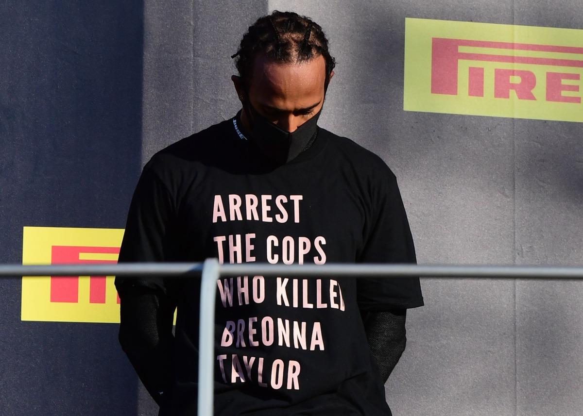 Formula One F1 - Tuscan Grand Prix - Mugello, Scarperia e San Piero, Italy - September 13, 2020 Mercedes' Lewis Hamilton wears a shirt in reference to Breonna Taylor on the podium as he celebrates after winning the race Pool via REUTERS/Jennifer Lorenzini