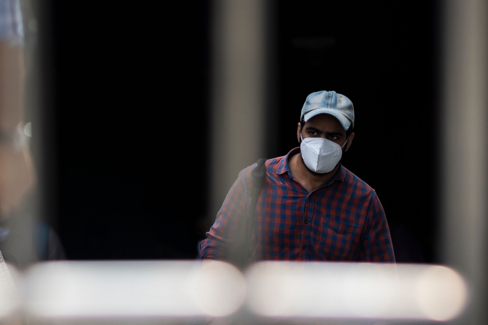 A commuter wearing a facemask as a preventive measure against the Covid-19 coronavirus walks out of a metro station in New Delhi on September 16, 2020. India's total coronavirus cases passed five million on September 16, health ministry data showed, as th