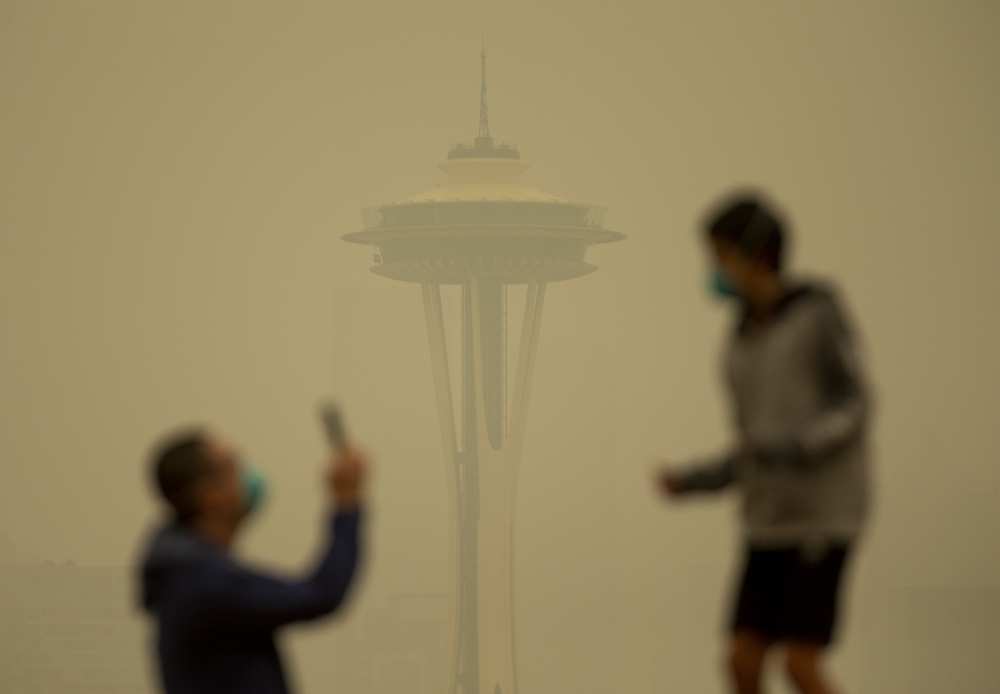People take photos against the backdrop of the Space Needle as smoke from wildfires fills the air at Kerry Park on September 12, 2020 in Seattle, Washington. Lindsey Wasson/Getty Images/AFP