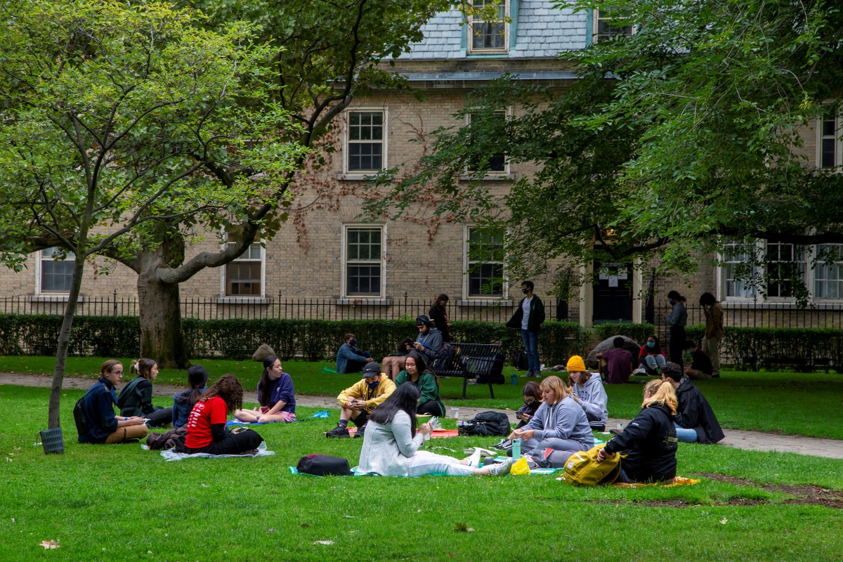 People sit on the grounds of the University of Toronto in Toronto, Ontario, Canada September 9, 2020. Picture taken September 9, 2020. REUTERS/Carlos Osorio
