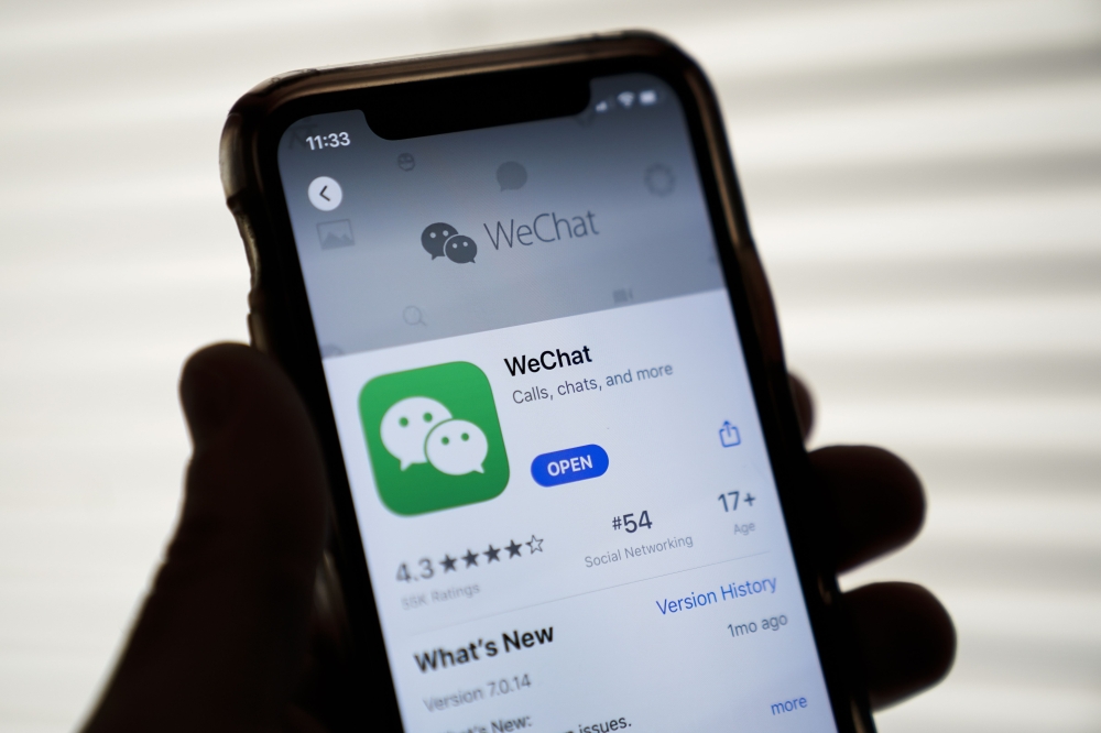 In this file photo illustration taken on August 07, 2020, the WeChat app is displayed in the App Store on an Apple iPhone in Washington, DC. US officials on September 18, 2020, ordered a ban on downloads of the popular Chinese-owned mobile applications We