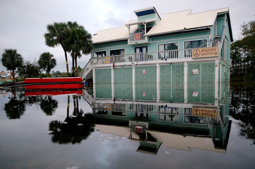 A house surrounded by flood waters is pictured after Hurricane Sally in Gulf Shores, Alabama. REUTERS/Jonathan Bachman/File Photo