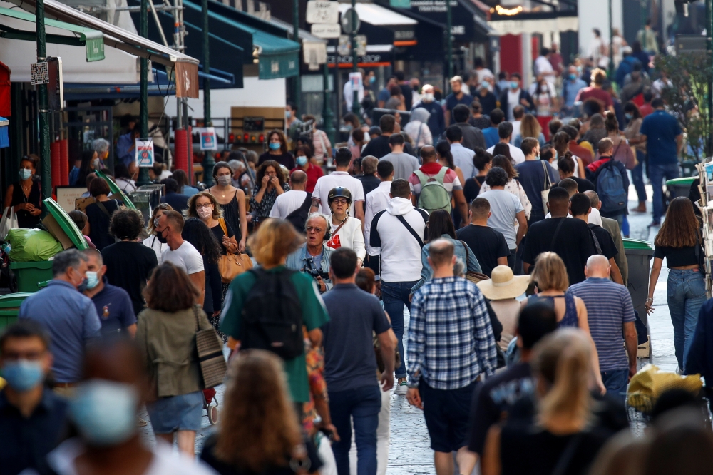 People wearing protective face masks walk in a busy street in Paris as France reinforces mask-wearing in public places as part of efforts to curb a resurgence of the coronavirus disease (COVID-19) across France, September 18, 2020. REUTERS/Gonzalo Fuentes