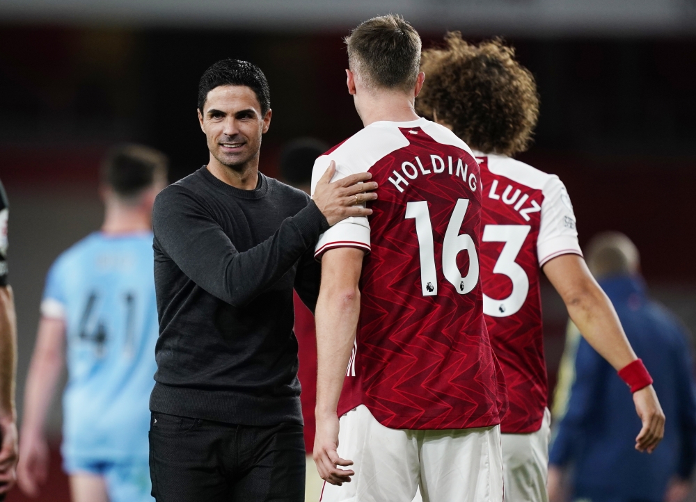 Arsenal manager Mikel Arteta and Arsenal's Rob Holding. REUTERS/Will Oliver