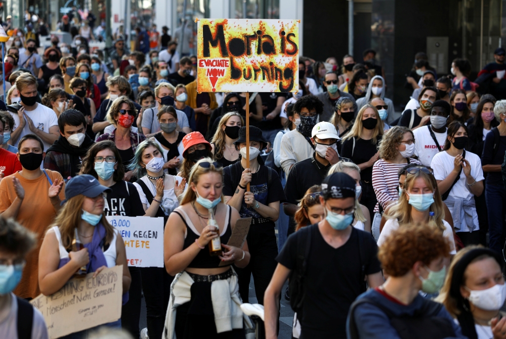 Protesters attend a demonstration demanding the evacuation of Greek overcrowded migrant camps and against the creation of a new camp on the Aegean island of Lesbos, in Berlin, Germany September 20, 2020. REUTERS/Christian Mang
