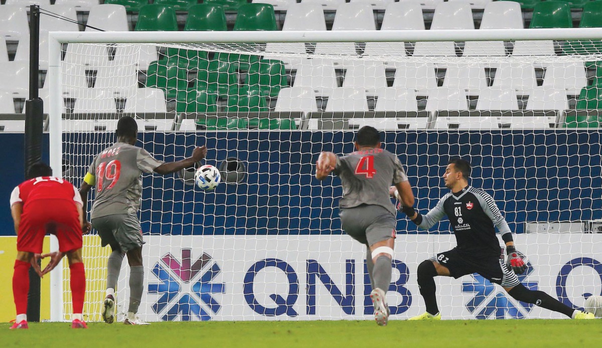 Al Duhail’s forward Almoez Ali (left) scores from a penalty spot against Iran’s Persepolis,  yesterday.