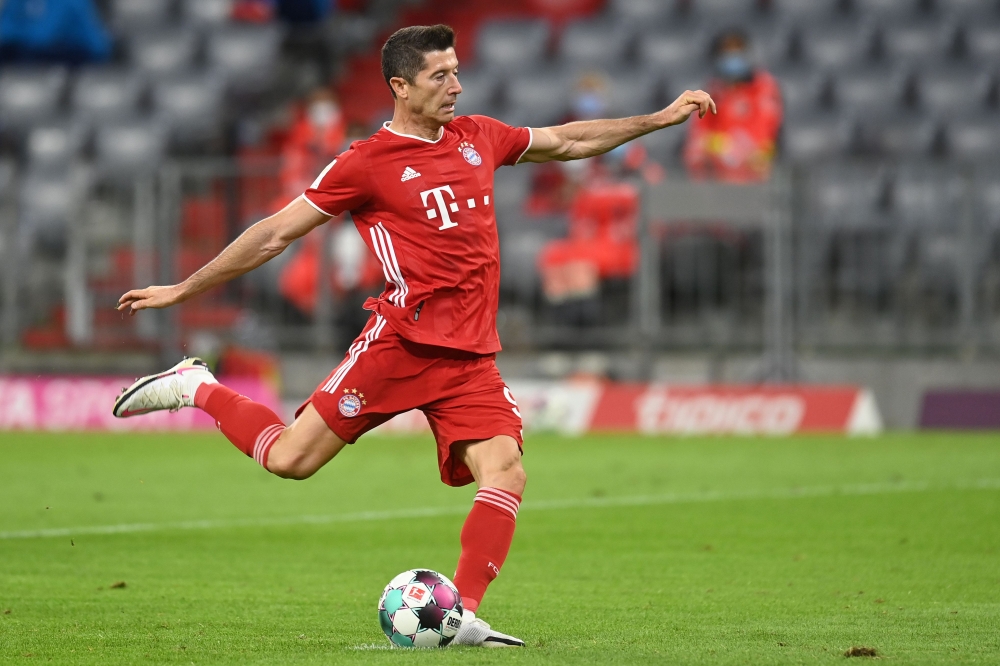 Bayern Munich's Polish forward Robert Lewandowski scores the third goal from the penalty spot during the German first division Bundesliga football match FC Bayern Munich v Schalke 04 in Munich, southern Germany on September 18, 2020. AFP / CHRISTOF STACHE