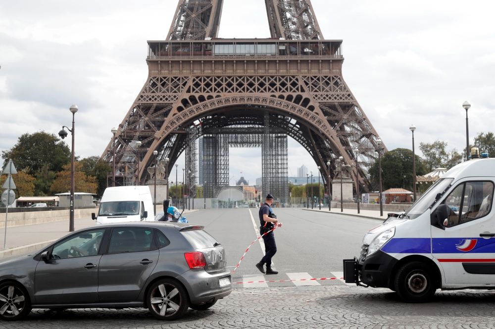 French police secure the area near the Eiffel Tower after the French tourism landmark was evacuated following a bomb alert in Paris, France, September 23, 2020. REUTERS/Charles Platiau