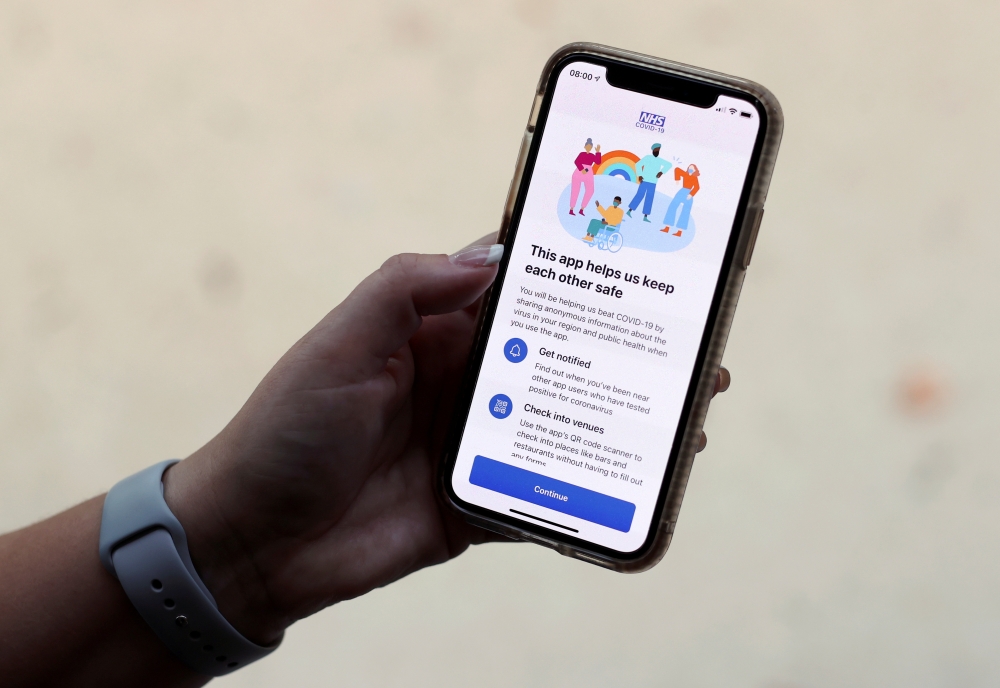 The coronavirus disease (COVID-19) contact tracing smartphone app of Britain's National Health Service (NHS) is displayed on an iPhone in this illustration photograph taken in Keele, Britain, September 24, 2020. REUTERS/Carl Recine/Illustration