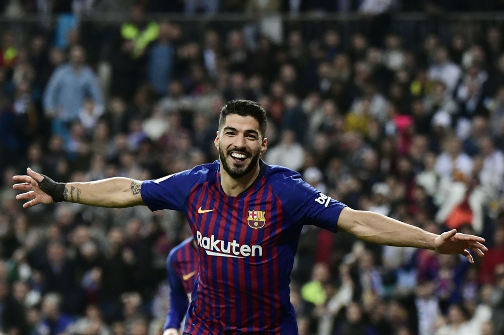 (FILES) In this file photo taken on February 27, 2019 Barcelona's Uruguayan forward Luis Suarez celebrates his second goal during the Spanish Copa del Rey (King's Cup) semi-final second leg football match between Real Madrid and Barcelona at the Santiago 