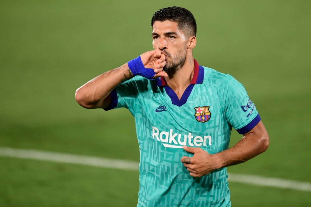 In this file photo taken on July 05, 2020 Barcelona's Uruguayan forward Luis Suarez celebrates after scoring a goal during the Spanish League football match between Villarreal and Barcelona at the Madrigal stadium in Villarreal. Atletico Madrid announced 