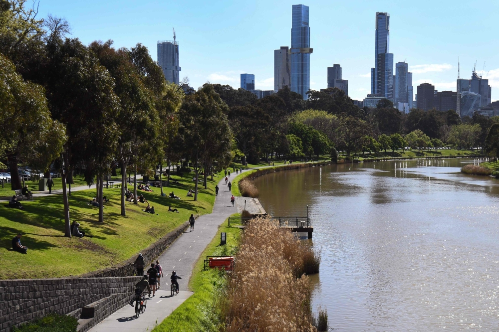 People exercise along the banks of the Yarra River in Melbourne on September 27, 2020 as an overnight curfew in Australia's second-biggest city will be lifted from September 28, almost two months after it was imposed to counter a surging COVID-19 coronavi