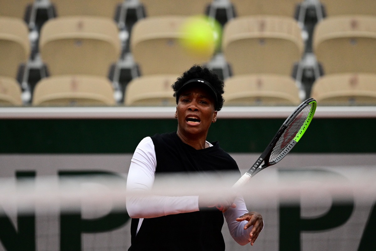 Venus Williams of the US reacts as she plays a return against Slovakia's Anna Karolina Schmiedlova during their women's singles first round tennis match at the Simonne Mathieu court on Day 1 of The Roland Garros 2020 French Open tennis tournament in Paris