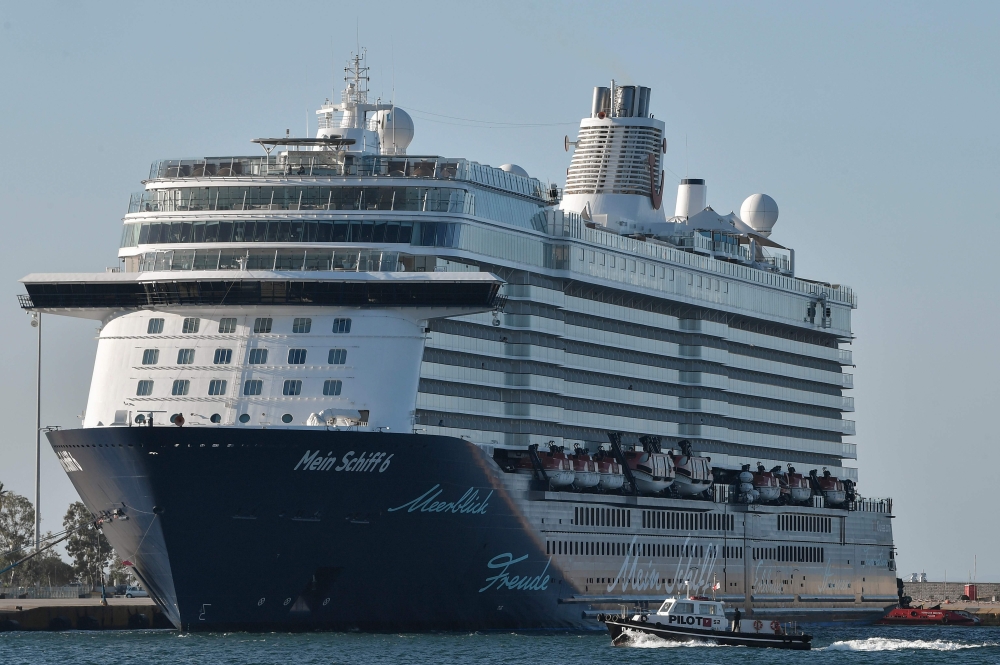 Maltese-flagged cruiser Mein Schiff 6, operated by German travel giant TUI is docked at the port of Piraeus early on September 29, 2020 after a dozen crew members were reported positive for the virus, state news agency ANA said. / AFP / LOUISA GOULIAMAKI