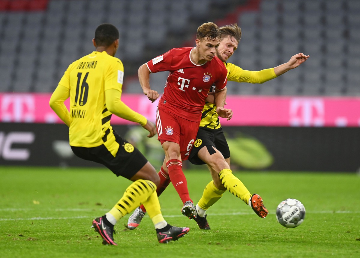 Soccer Football - DFL-Supercup - Bayern Munich v Borussia Dortmund - Allianz Arena, Munich, Germany - September 30, 2020 Bayern Munich's Joshua Kimmich an action before scoring their third goal Christof Stache/Pool via REUTERS DFL regulations prohibit any