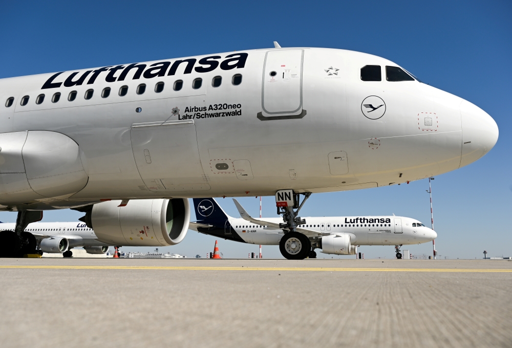 FILE PHOTO: Two Airbus A320neo airplanes of German carrier Lufthansa are parked as air traffic is affected by the spread of the coronavirus disease (COVID-19), in Frankfurt, Germany, March 23, 2020. Arne Dedert/Pool via REUTERS/File Photo