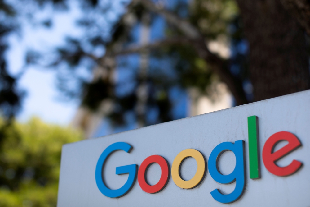 FILE PHOTO: After the company announced it would extend its coronavirus work-from-home order until summer 2021, a Google sign is shown at one of the company's office complexes in Irvine, California, U.S., July 27, 2020. REUTERS/Mike Blake