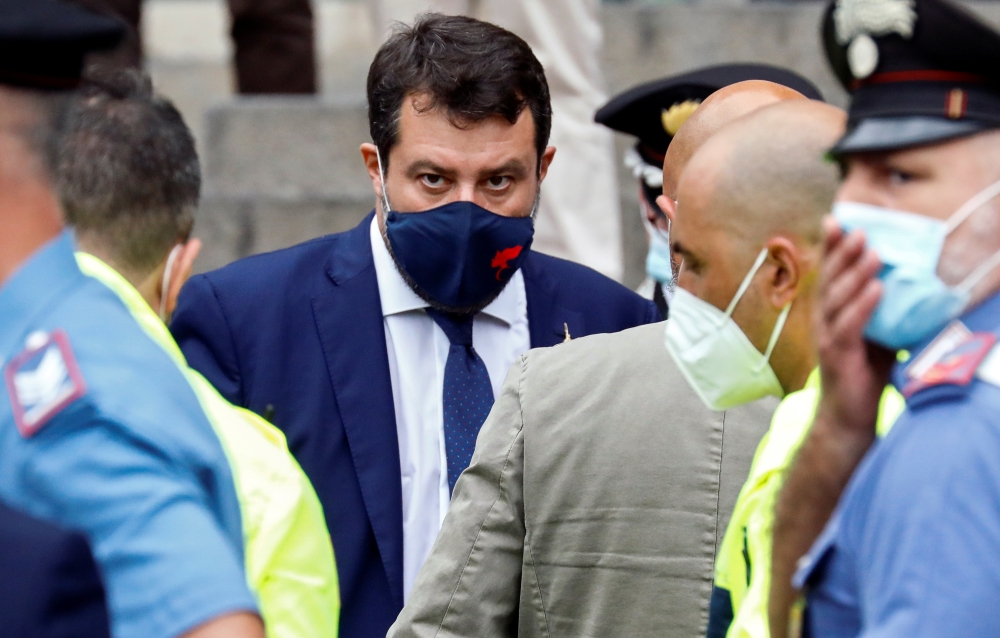Far-right leader Matteo Salvini stands next to his lawyer, Giulia Bongiorno while she is assisted by medical personnel outside the court in Catania, Italy, October 3, 2020. REUTERS/Antonio Parrinello