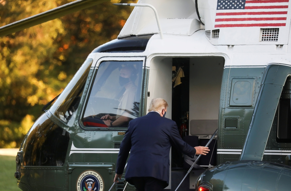 U.S. President Donald Trump boards the Marine One helicopter to depart the White House and fly to Walter Reed National Military Medical Center, where it was announced he will stay for at least several days after testing positive for the coronavirus diseas